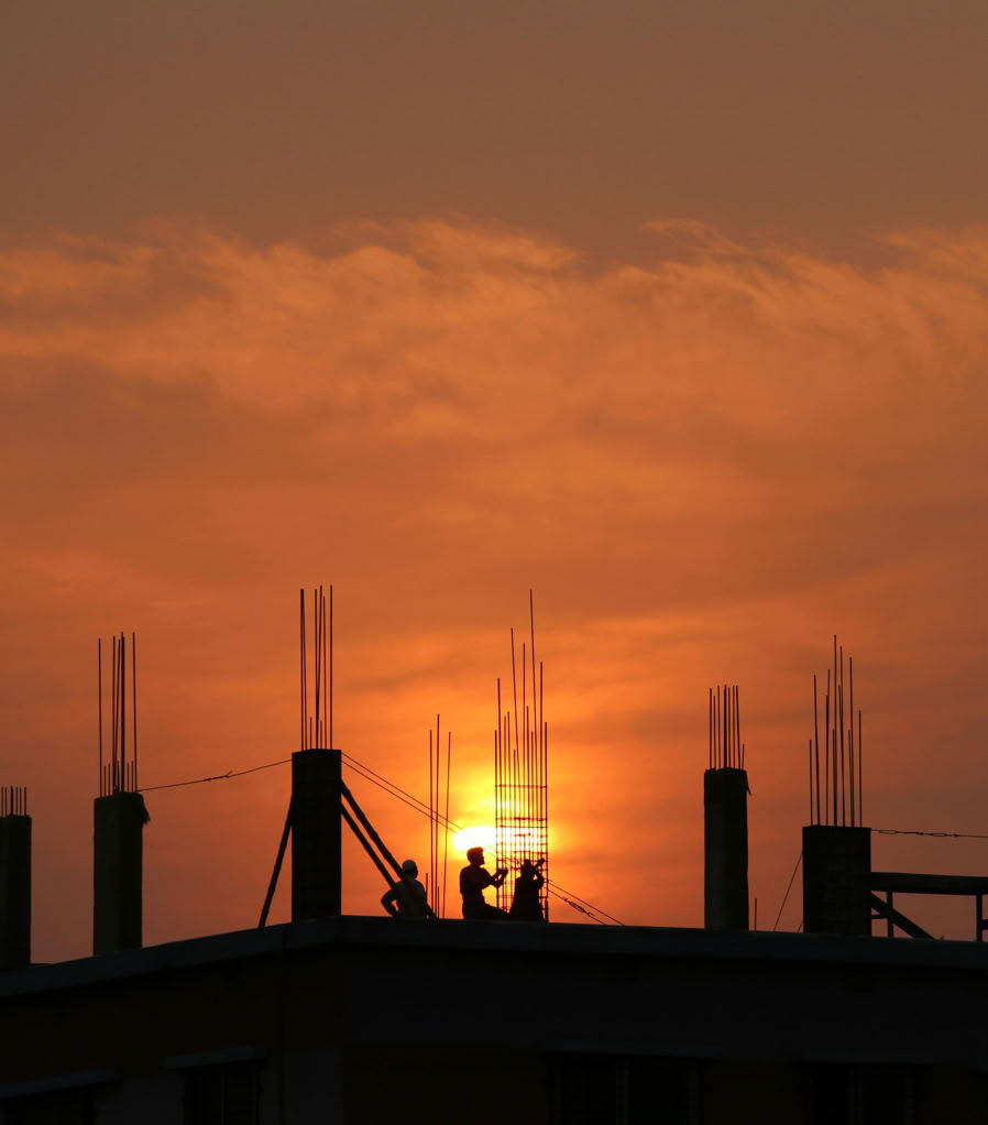 Silhouette of Men in Construction Site during Sunset